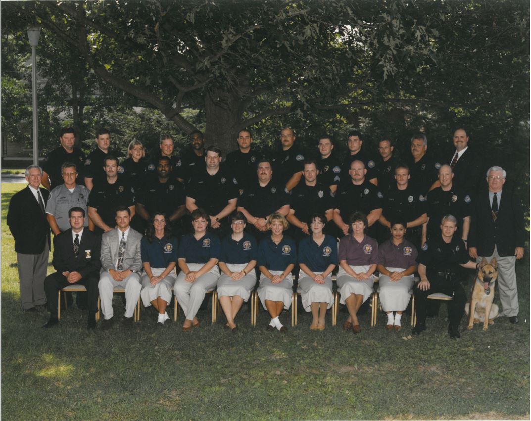 First Row (L to R): Captain David Moore, Brian Duke, Gale Pruitt, Vicki Adams, Mary Drewry, Dawn Gallimore, Erica Griffin, Billie Mollyhorn, Kim Boyd, Jimmy Davis, K-9 Leo Second Row: Mayor Larry Taylor, Larry Baker, Sammy Liles, Terry Guthrie, Doug Hollandsworth, Ed McGee, Robby Hatler, Ricky Lundsford, David Blurton, Captain Don Teal, City Recorder Dick Tidwell Third Row: Captain Alan Hazlewood, Todd Wright, Valerie Troutt, Stacey Bostwick, Dean Brooks, Tommy Erwin, Andy Phelps, Sergeant Mike Wilson, Shane Anderson, Joel Griffith, Ron Powers, Chief J. D. Sanders